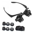 Black hands-free LED magnifying glasses with interchangeable lenses on a headband for watch repair.
