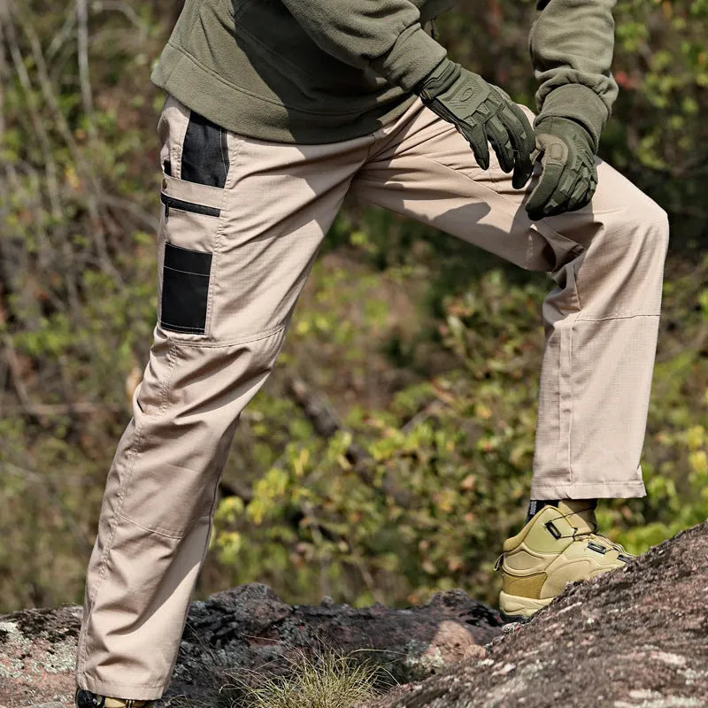 Men's multi-pocket water repellent outdoor trousers in army green, front view showing pockets and fabric texture