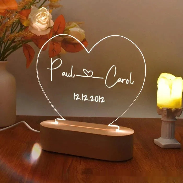 Custom transparent acrylic LED night light etched with personal names and date.