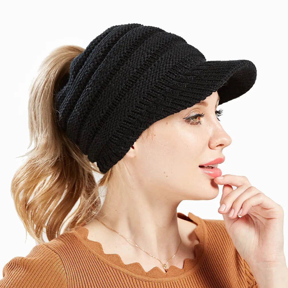 Women's knitted acrylic beanie hat designed for wearing with a ponytail or bun.