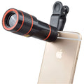 Black and white 12X phone telescope with mounting clip on a mobile phone for telephoto photography