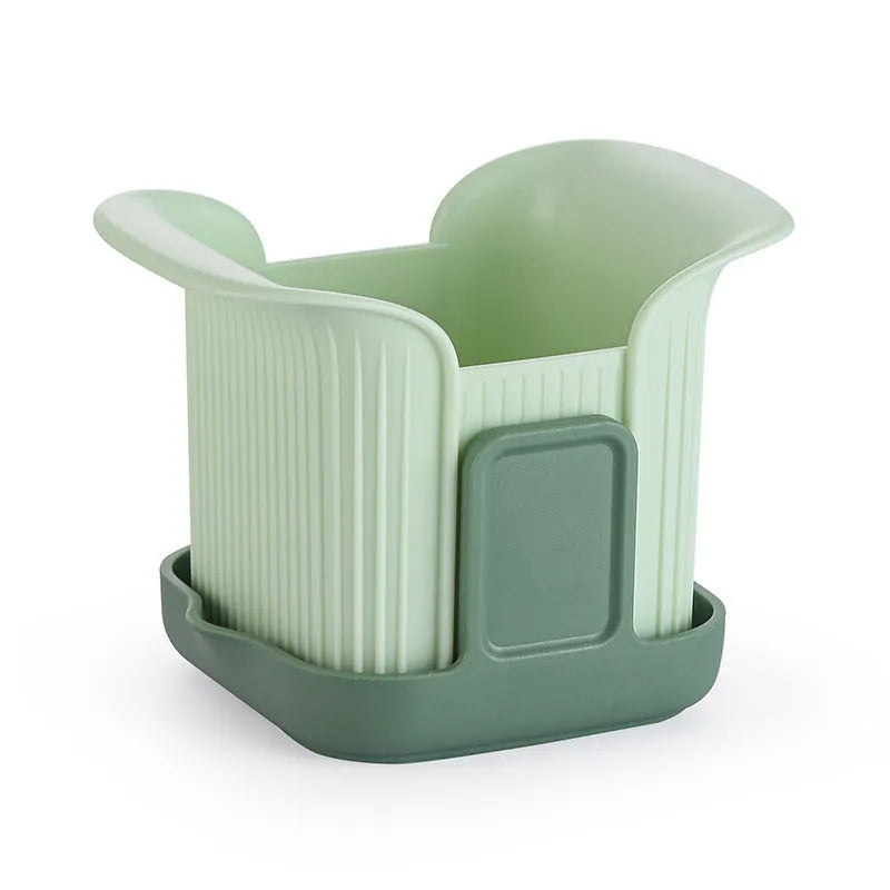 Green manual vegetable chopper with stainless steel blades for slicing potatoes and dicing onions.