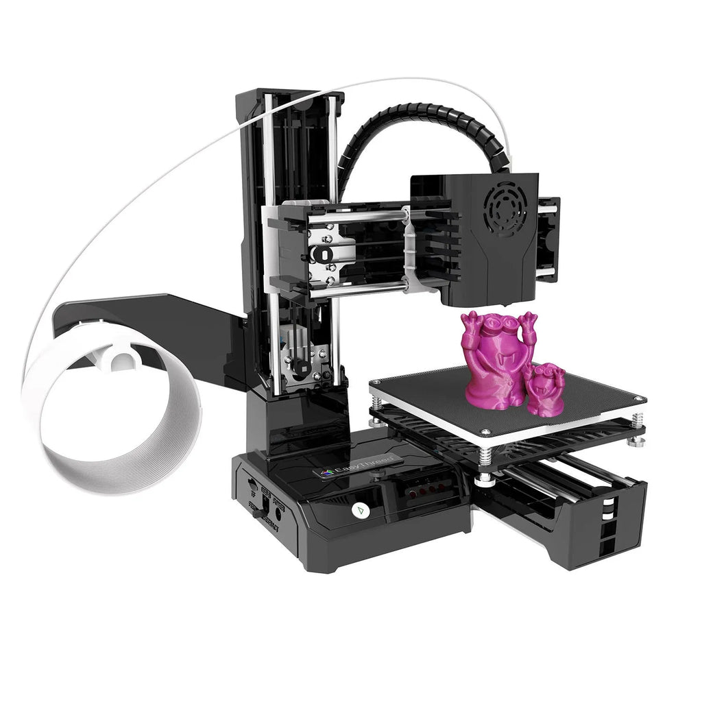 K9 New Mini 3D Printer on a desktop with a small printed toy model next to it.