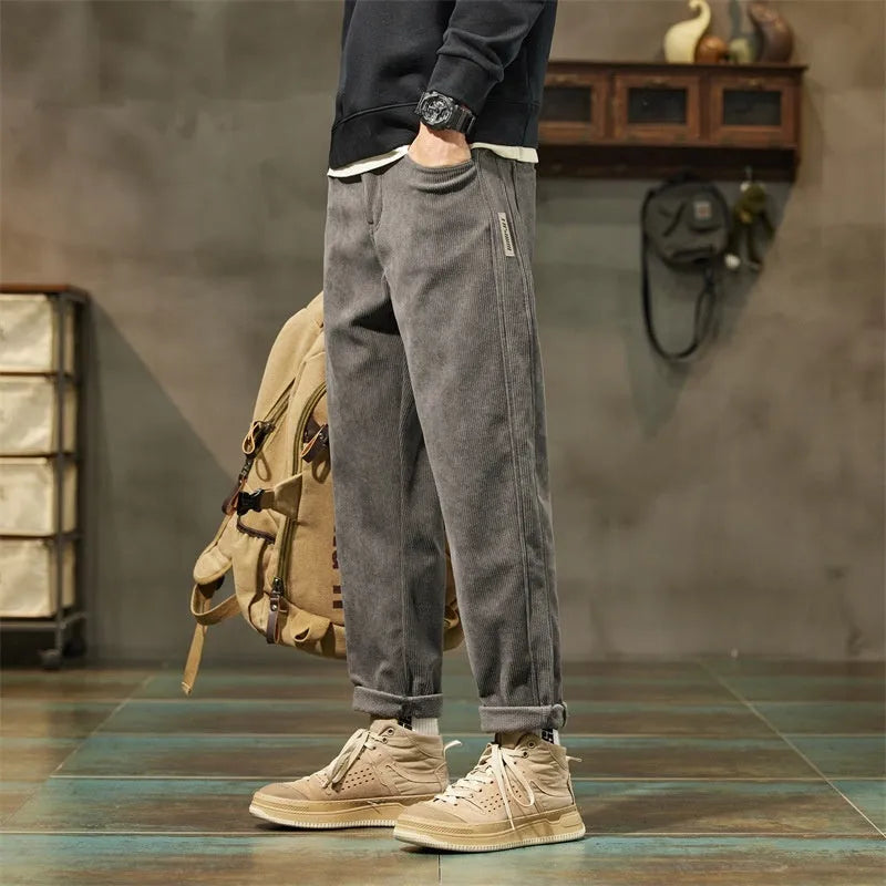 Men's corduroy casual trousers in tapered straight-leg style with mid waist and zipper fly closure