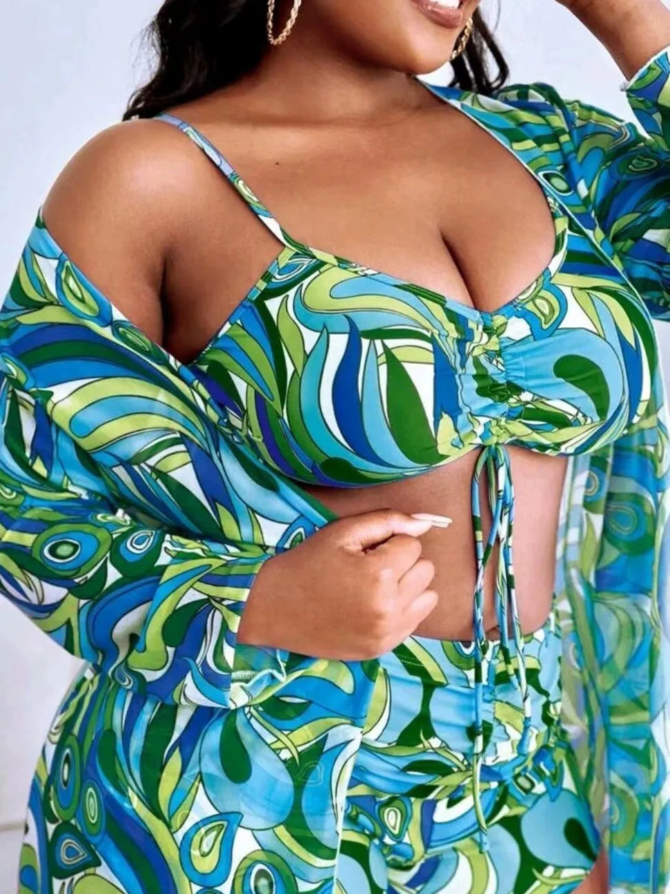 Women's floral print bikini three-piece set with bra, briefs, and cardigan cover-up.