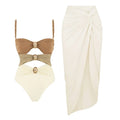 Women's black one-piece swimsuit with a detachable skirt and a gold button detail on the front