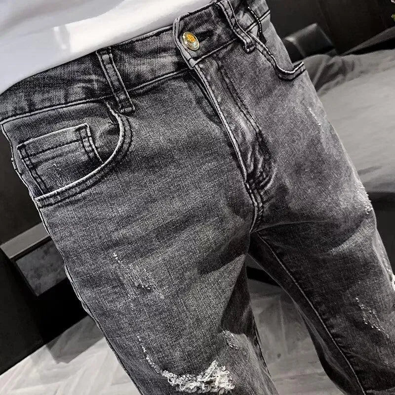 Man's high-waist blue denim jeans with a button fly on a plain background.
