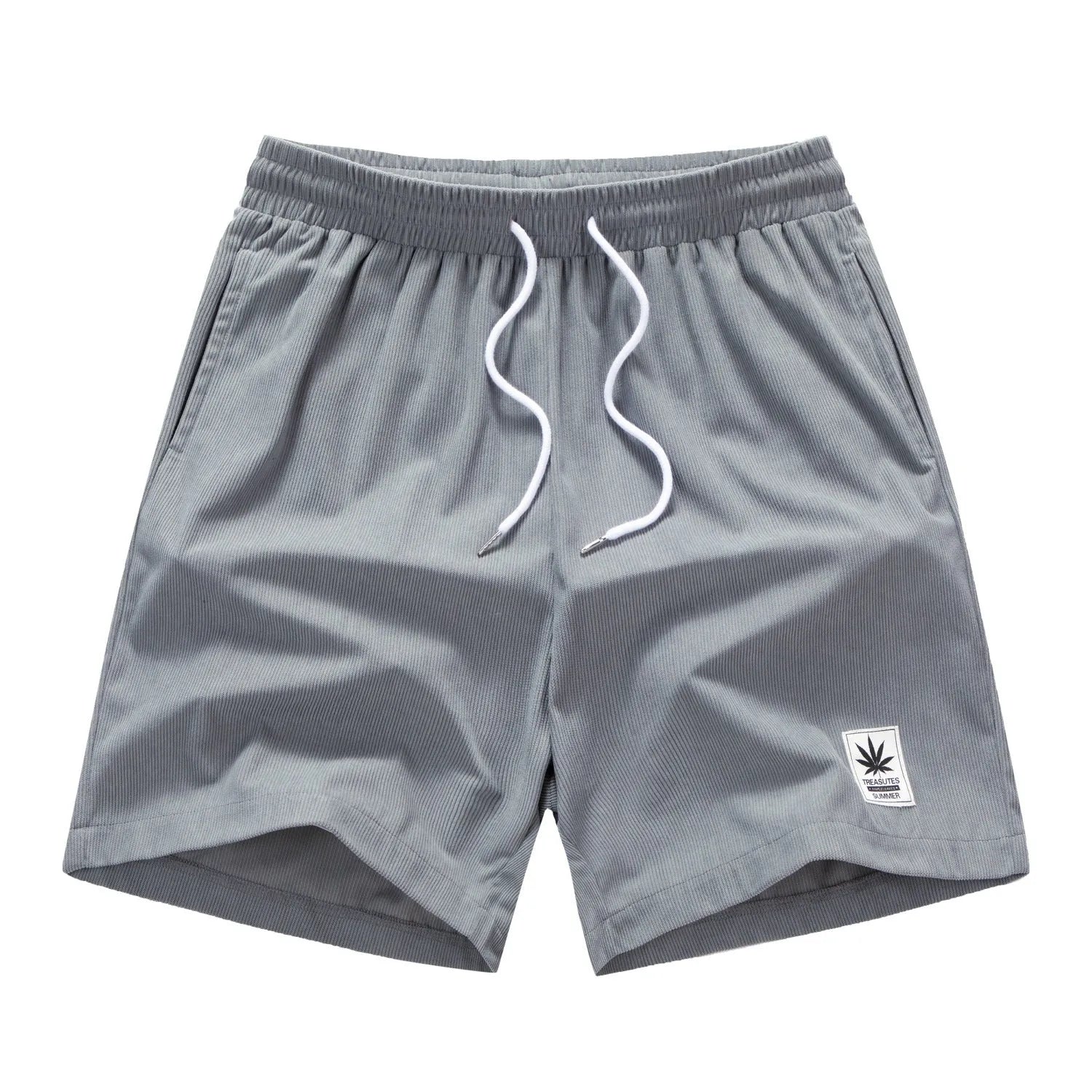Man wearing grey straight-cut elastic drawstring summer shorts on a beach.