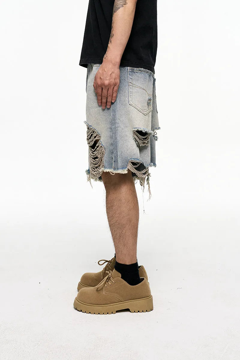 Light blue men's baggy denim shorts with a wide leg cut and mid waist on a plain background