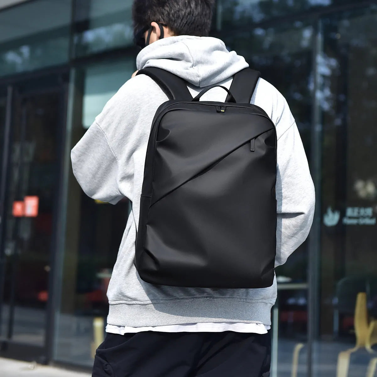 Large waterproof PU leather backpack for men in black, shown with computer compartment