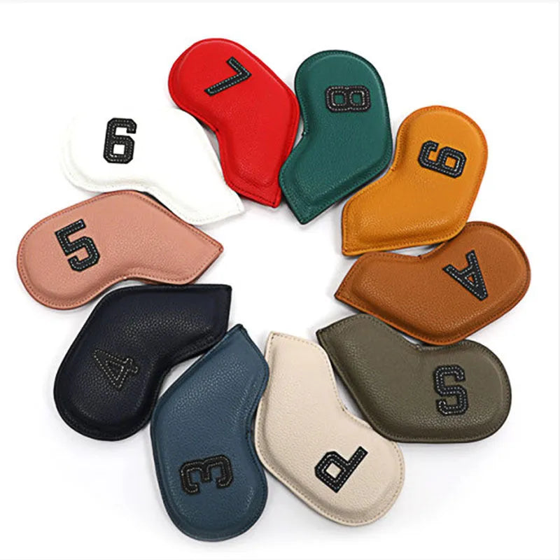 Set of 10 assorted coloured PU leather golf club head covers on a green background.