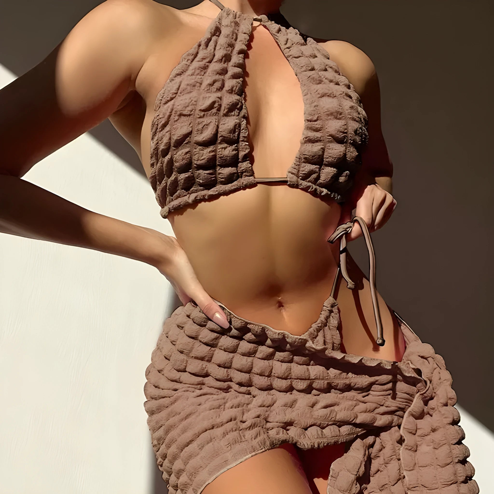 Brown seersucker three-piece bikini swimsuit with lace-up top, matching pants, and skirt for women