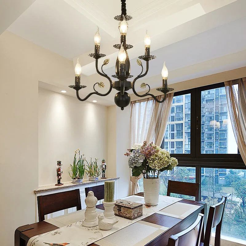 Black wrought iron candle crystal chandelier with 6 lights in a living room setting