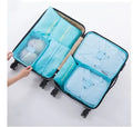 Six waterproof nylon packing cubes and organiser bags in various colours with mesh panels for travel
