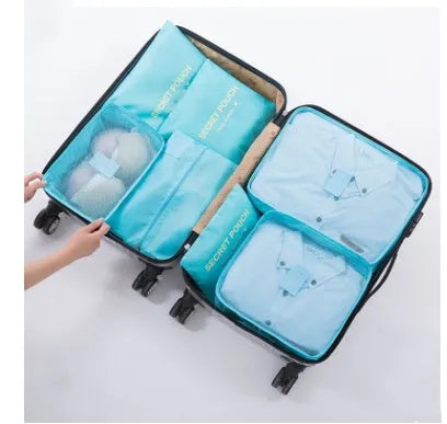 Six waterproof nylon packing cubes and organiser bags in various colours with mesh panels for travel