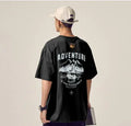 Plus size man modelling a loose fit short-sleeved t-shirt in black, dark grey, or white.