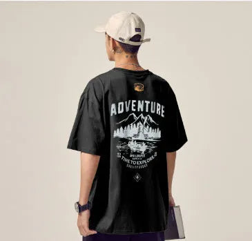 Plus size man modelling a loose fit short-sleeved t-shirt in black, dark grey, or white.