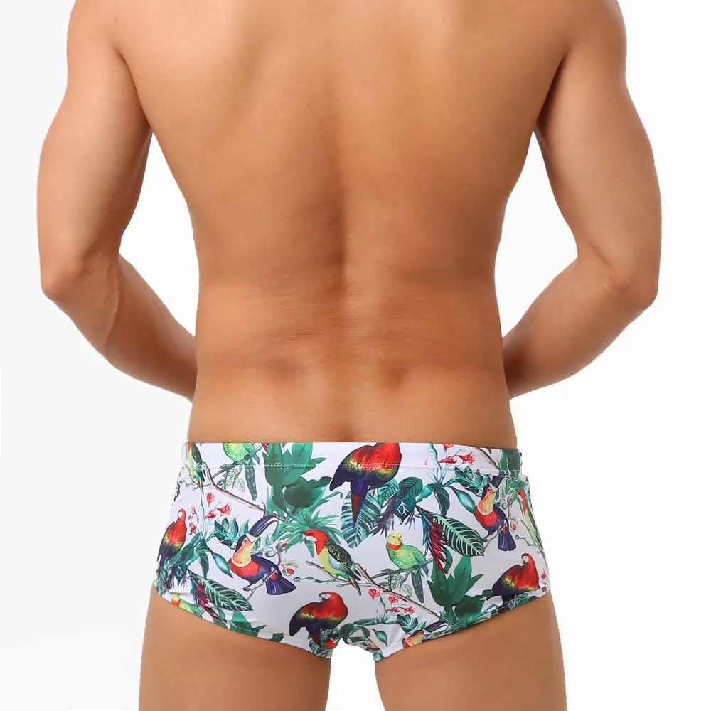 Men's swimming trunks with flower-bird print pattern in nylon fabric showing briefs style