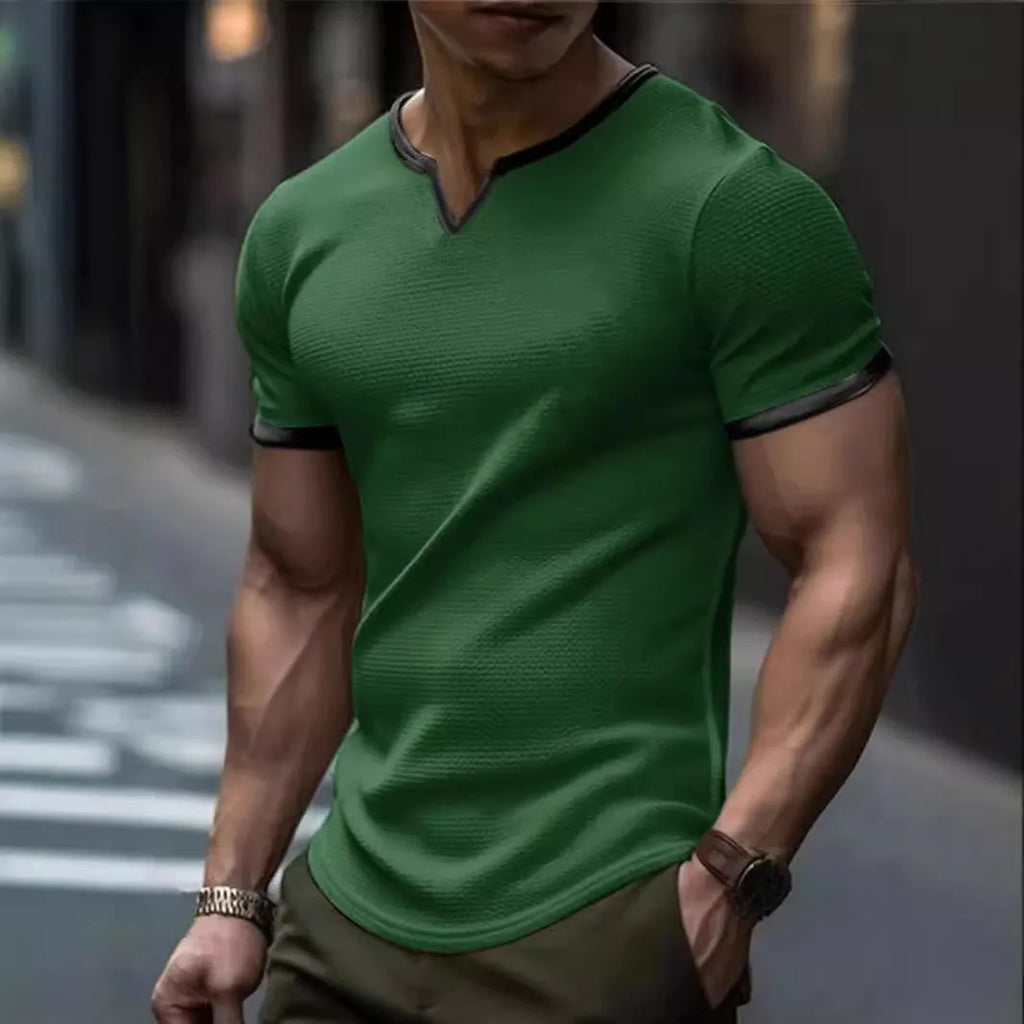 Man wearing a grey and white colour-block V-neck waffle knit short sleeve T-shirt.