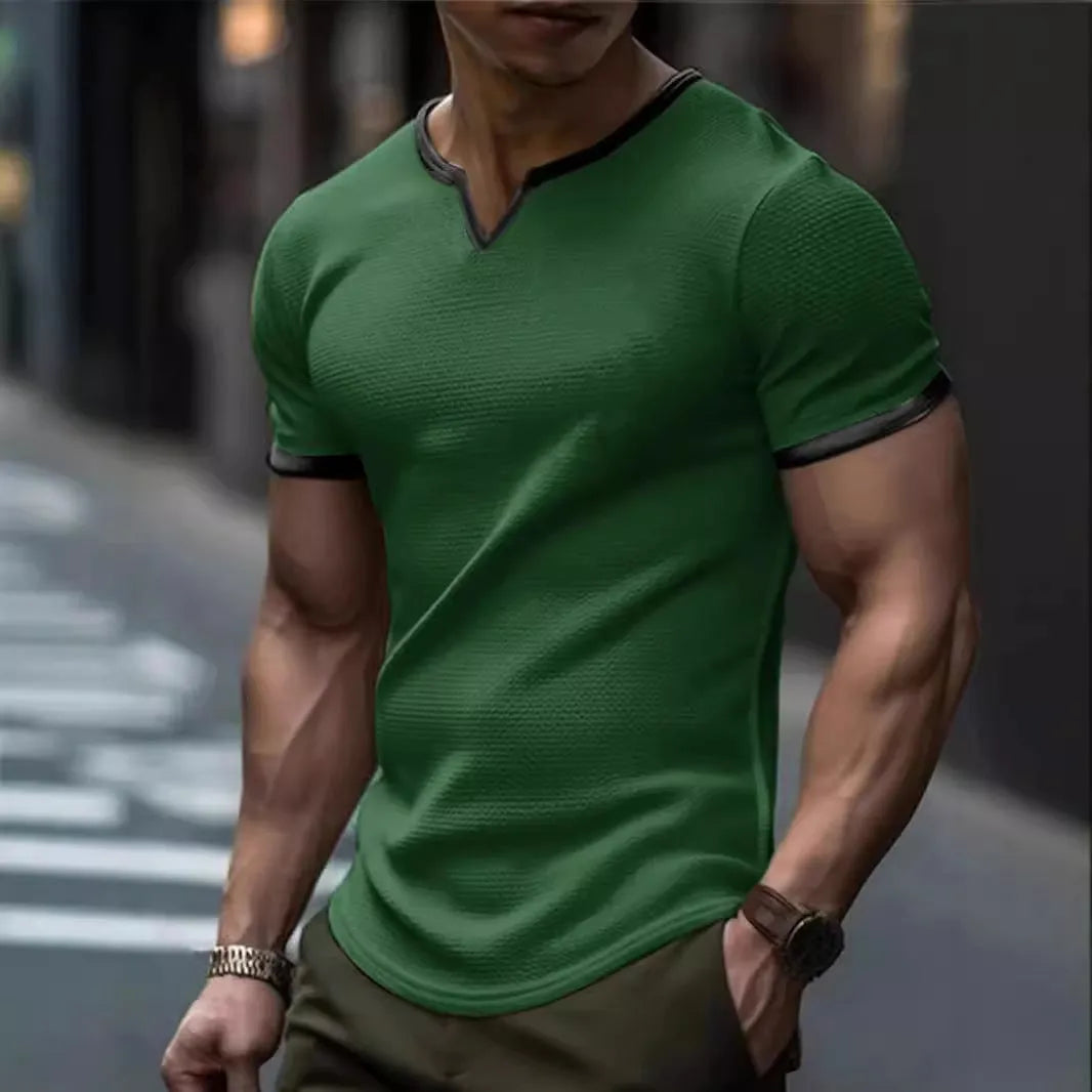Man wearing a grey and white colour-block V-neck waffle knit short sleeve T-shirt.