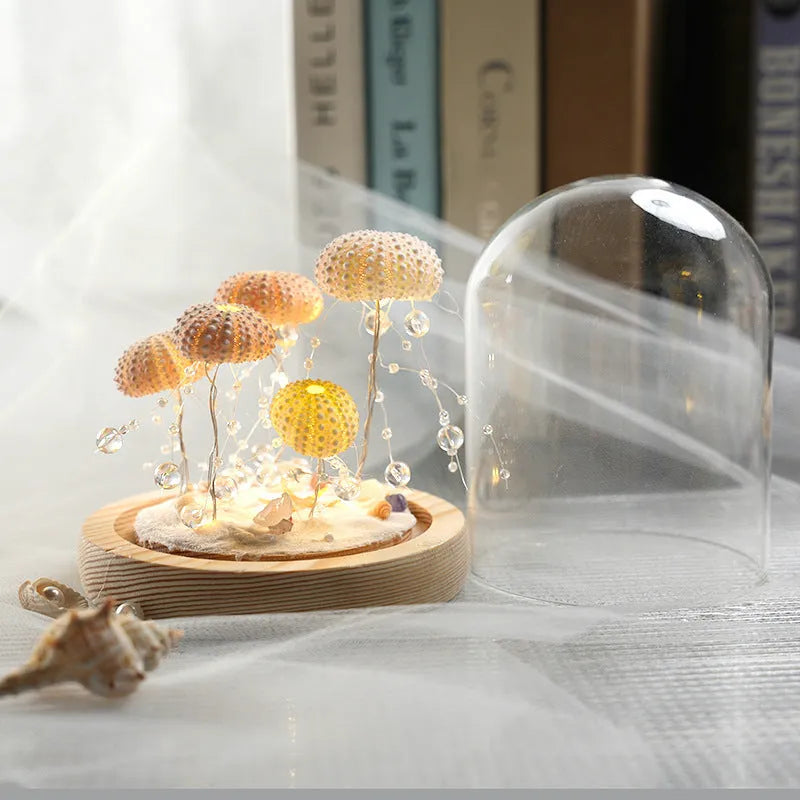 Handmade sea urchin shell jellyfish lamp inside a cylindrical clear glass cover, creative night light with built-in battery