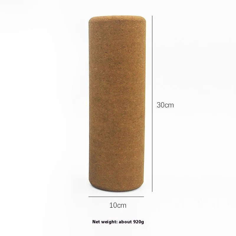 Natural cork yoga wand cylinder 30x10cm massage roller on a yoga mat with green background