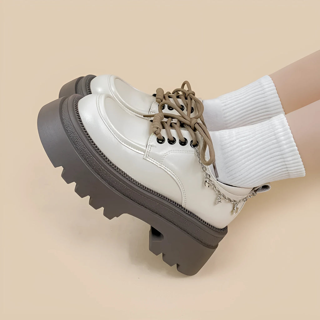 White women's platform Mary Jane shoes with a chunky heel and front lace-up fastening.
