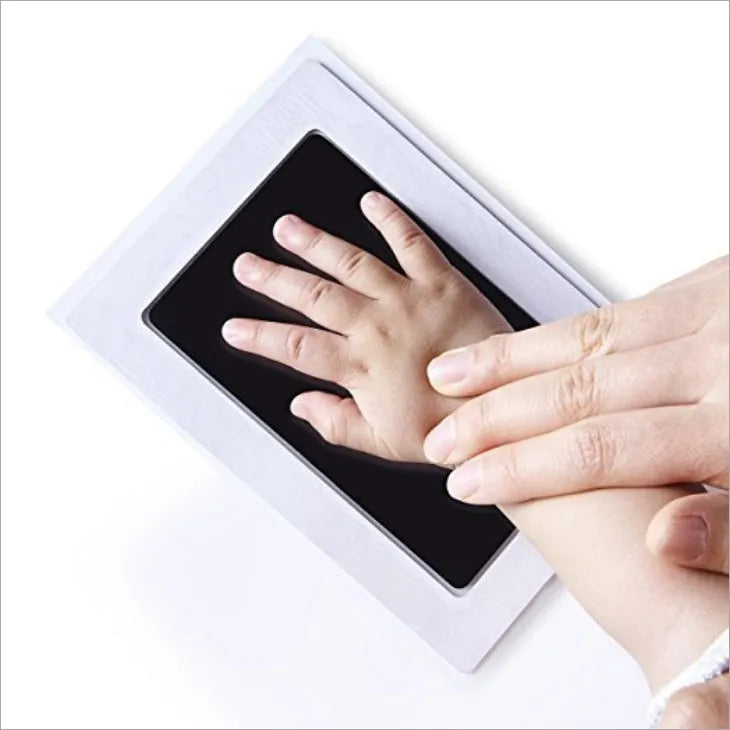 Baby hand and footprint ink pad set with non-toxic washable ink in black red and blue colours on white background