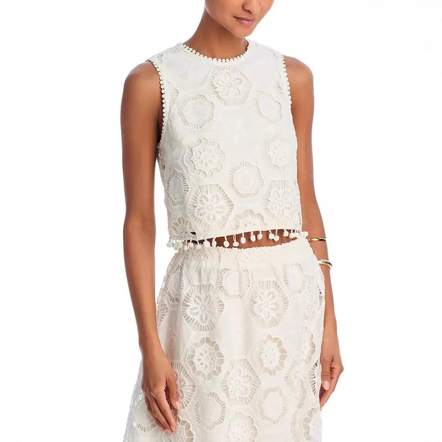 White women's retro-style two-piece suit with sleeveless top and embroidered long skirt.