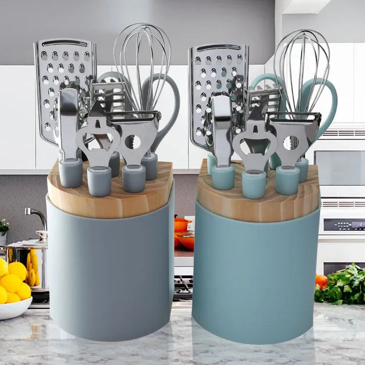 Stainless steel kitchen gadgets set with whisk, peeler, scissors, and fruit knife on grey tray