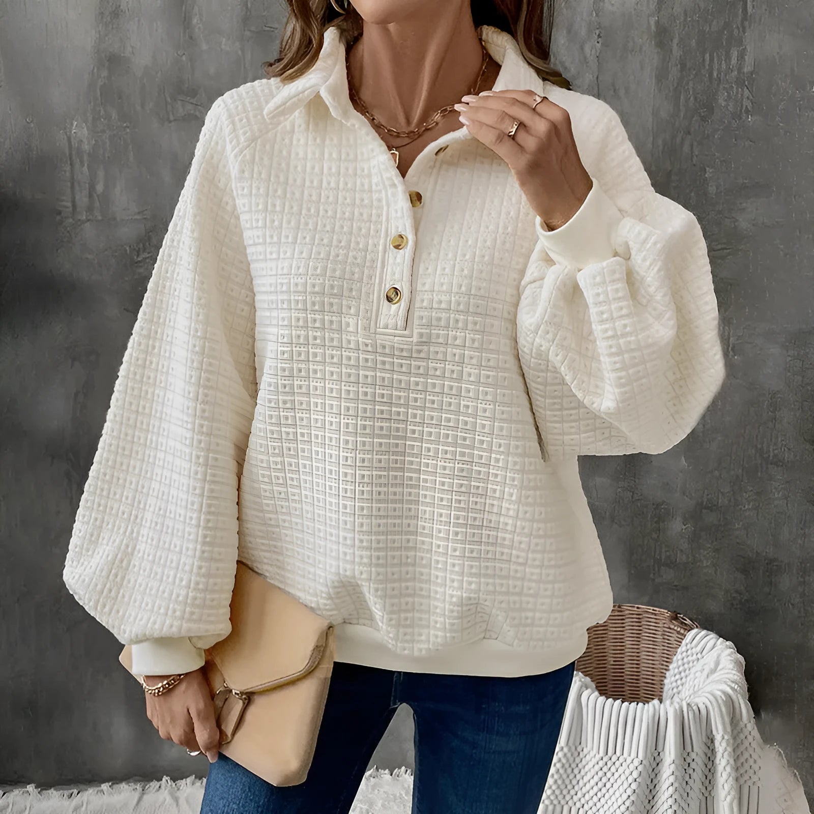 Women's milky white polo collar pullover sweater with long sleeves on a hanger.