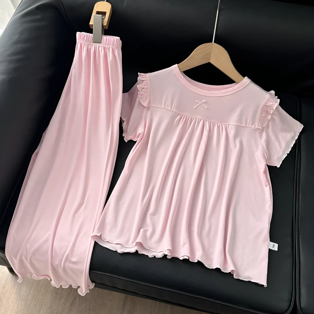 Girls' short sleeve modal pajama suit in solid colour, including top and pants, on a plain background