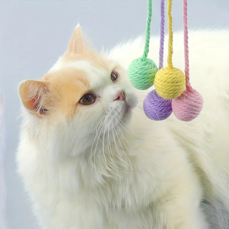 Fabric cat toy ball with rope attached in green, pink, purple, or yellow colours