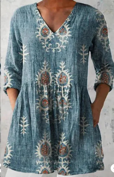 Women's loose-fitting dress with a wave print pattern, wide waist, and three-quarter length sleeves.