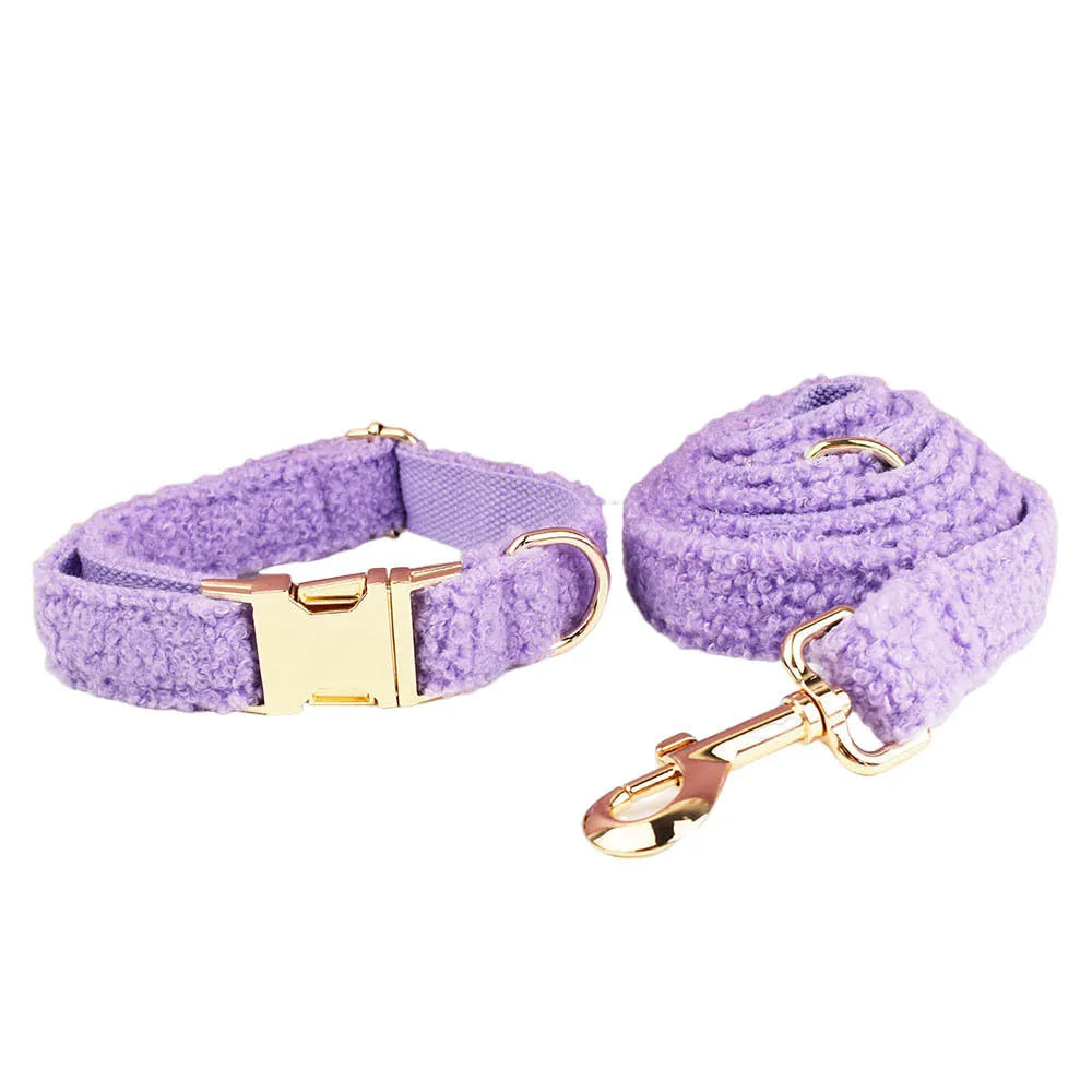 Purple cloth dog collar, lead, bow, and vest set laid out flat, showing the four matching accessories.