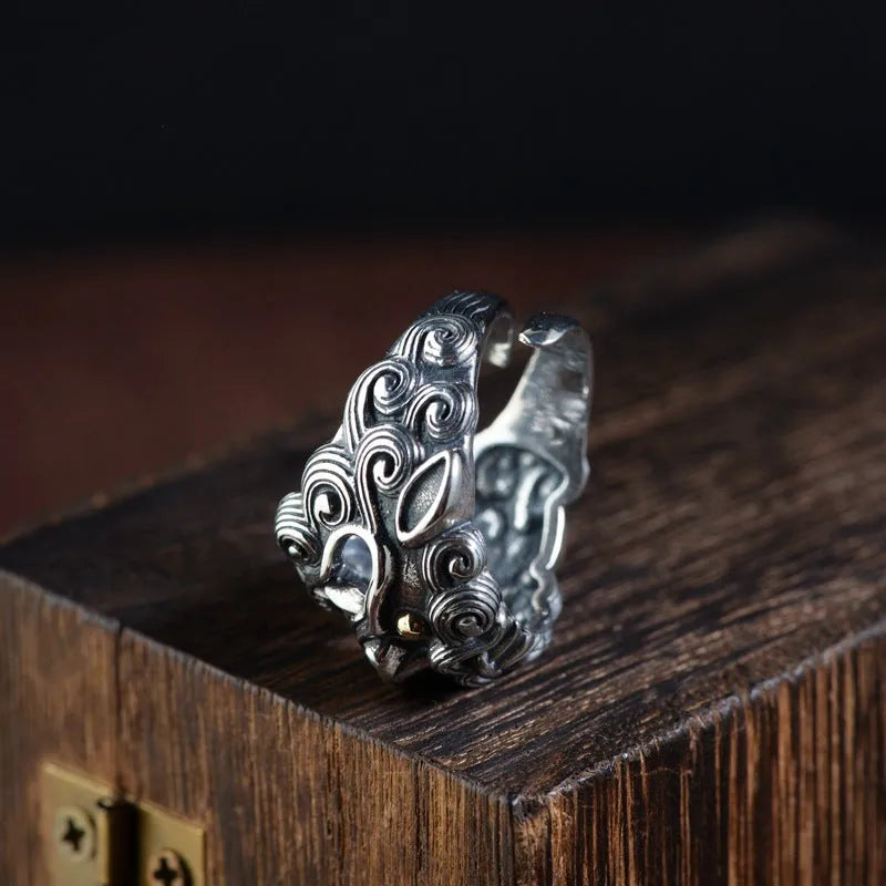 Silver open ring with a jibeast pattern, animal zodiac modelling, and a personalised diamond element.