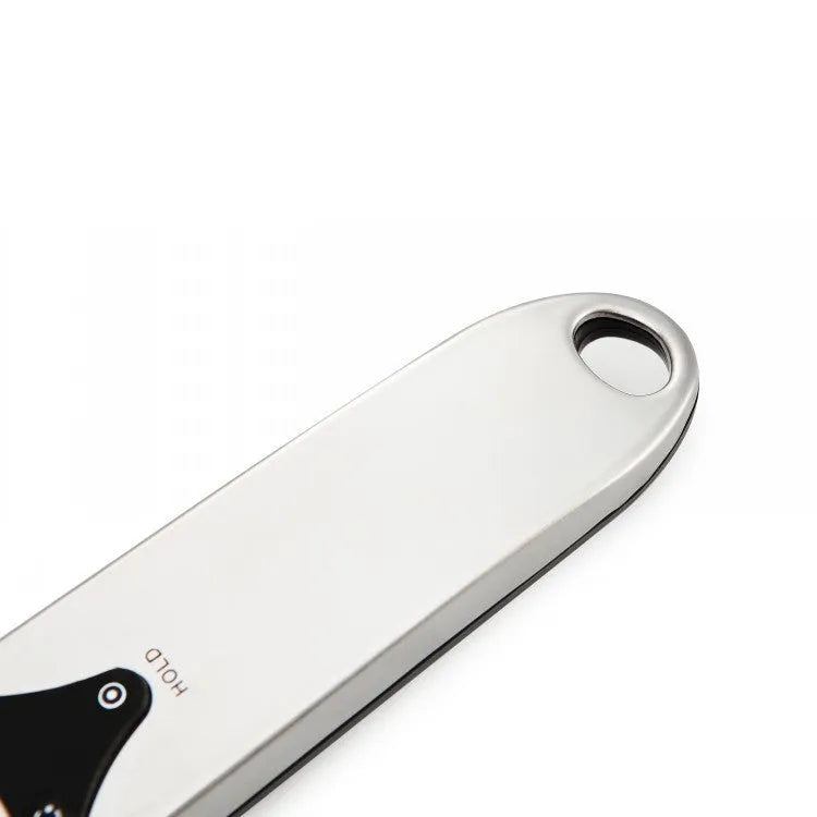 Smart digital kitchen measuring spoon with LCD display showing weight measurement.