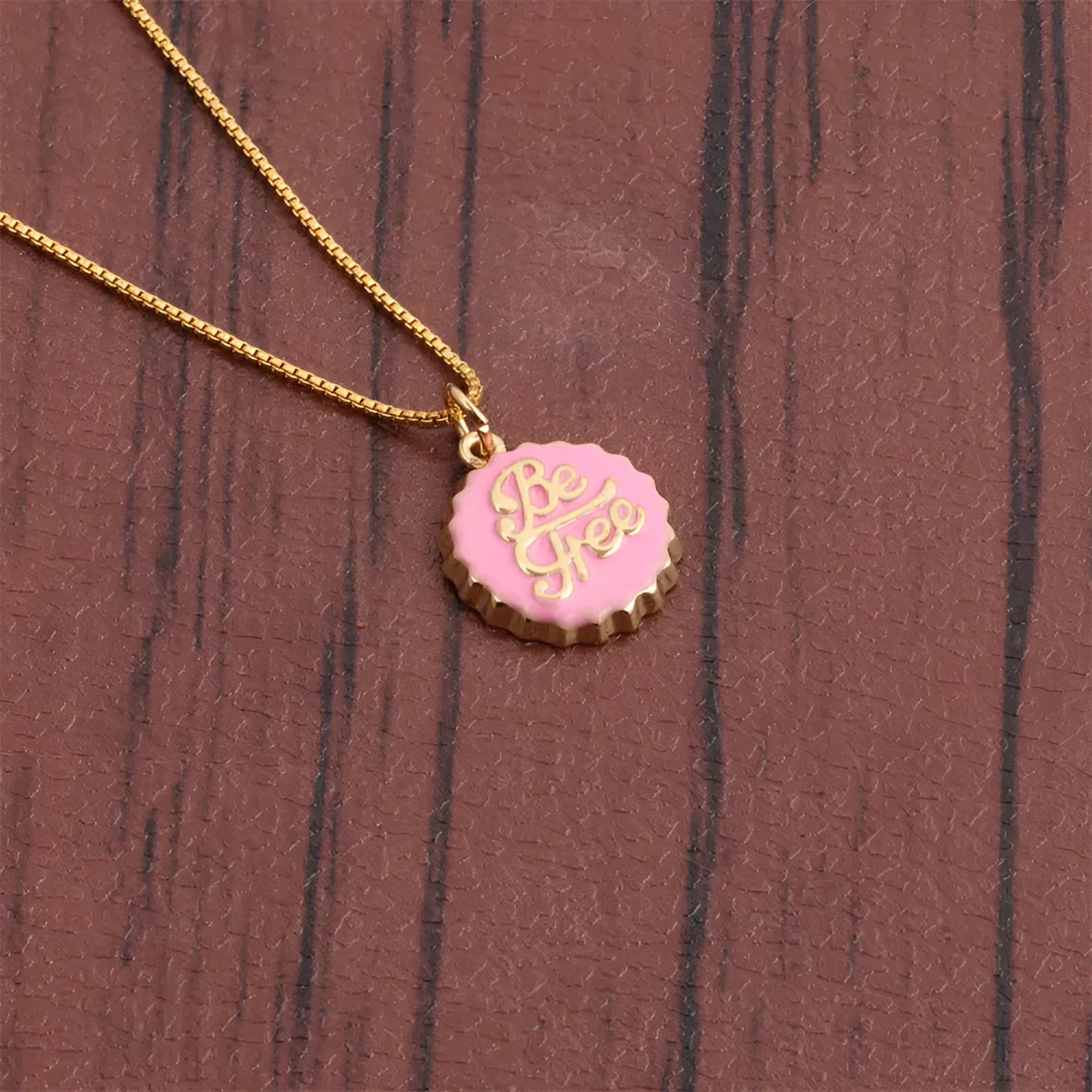 Copper bottle cap pendant necklace with electroplated gold finish on a 40cm box chain.