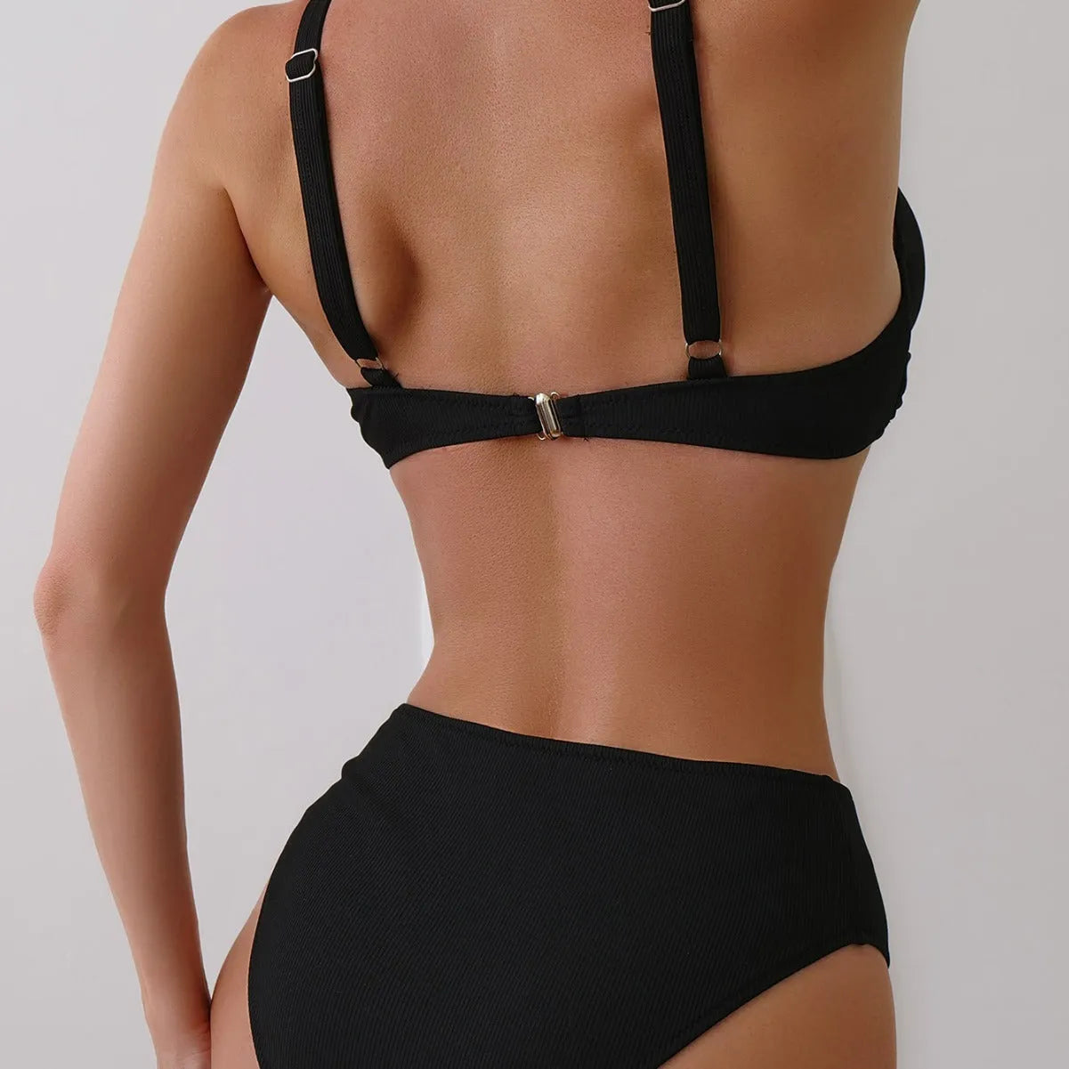 Women's solid colour rib fabric bikini set in black, green, or blue.