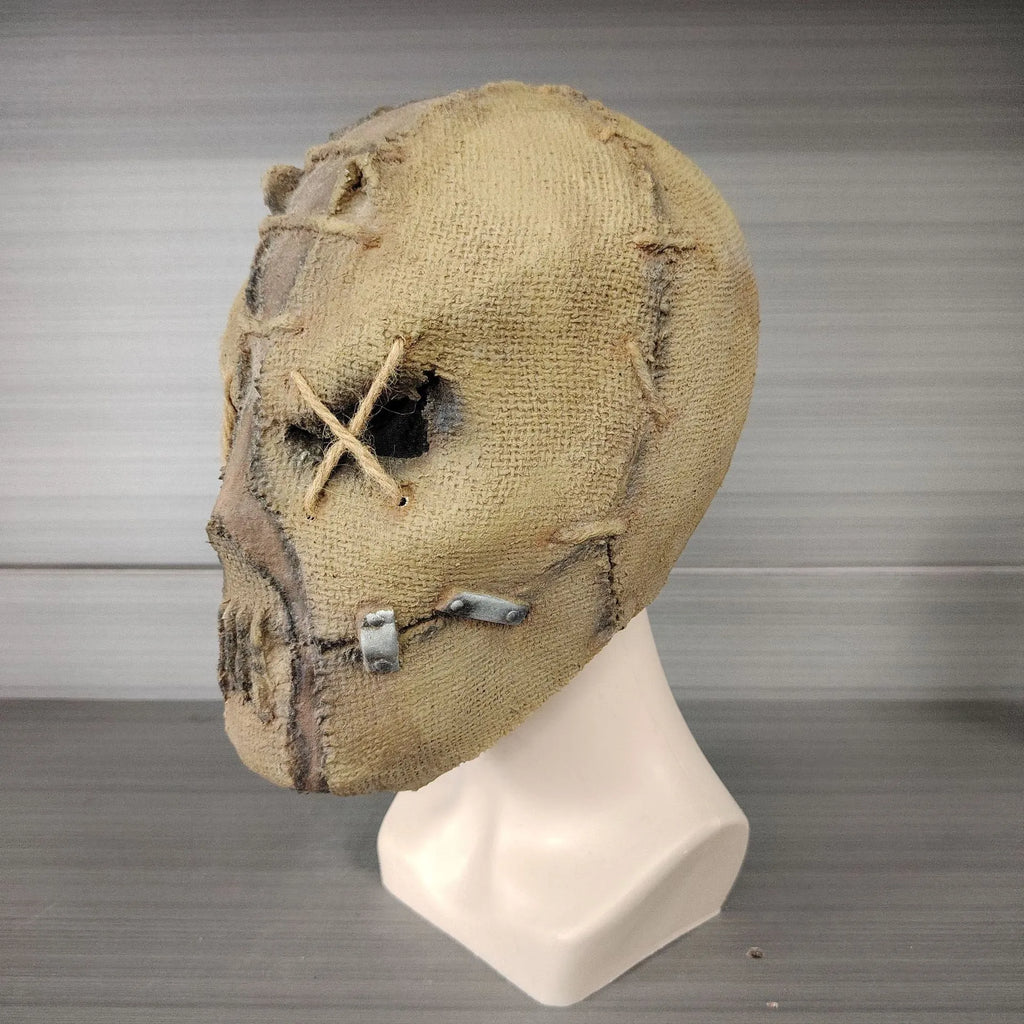 Latex Halloween horror mask with detailed scar skull design on a white background.