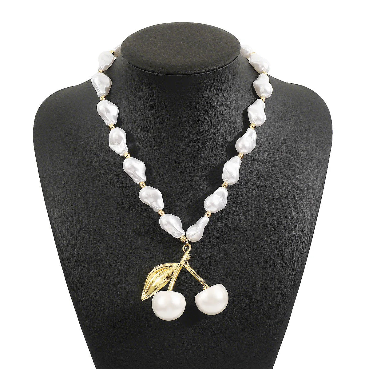 Gold-coloured adjustable necklace with a fruit-shaped pendant on a pearl-style chain.