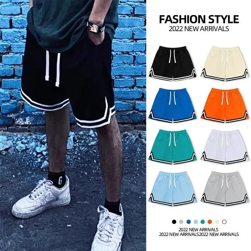 Man wearing loose grey polyester sports shorts with an elasticated waistband.