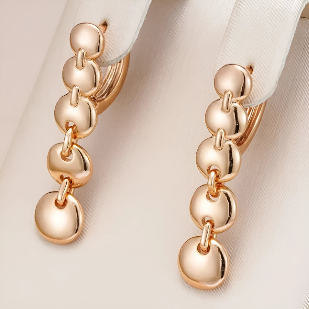 Gold-coloured retro woven round copper earrings showing textured circle design.