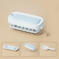 A high-capacity ice cube tray grid in a choice of colours, shown with its integrated ice shovel storage compartment.