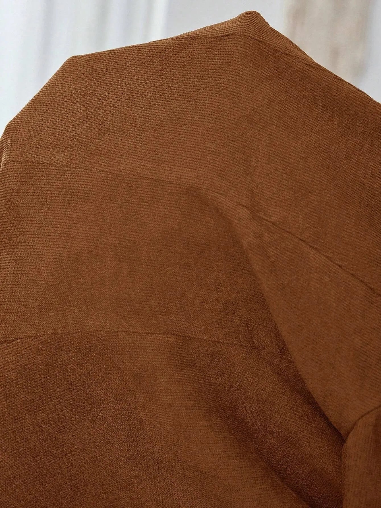 Brown single-breasted men's suit blazer with notch lapels on hanger