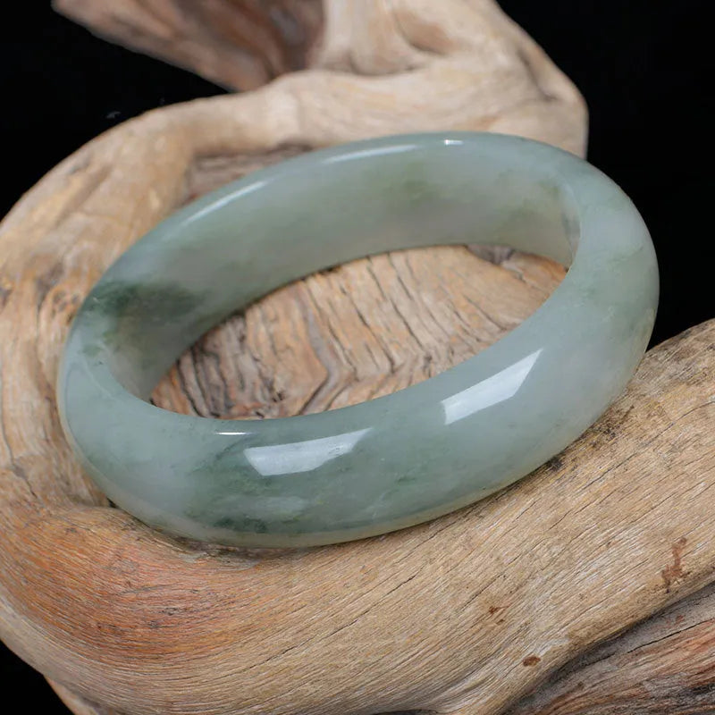 Natural Tianshan Jinsi Jade Chinese style bracelet showing circular form on a plain background.