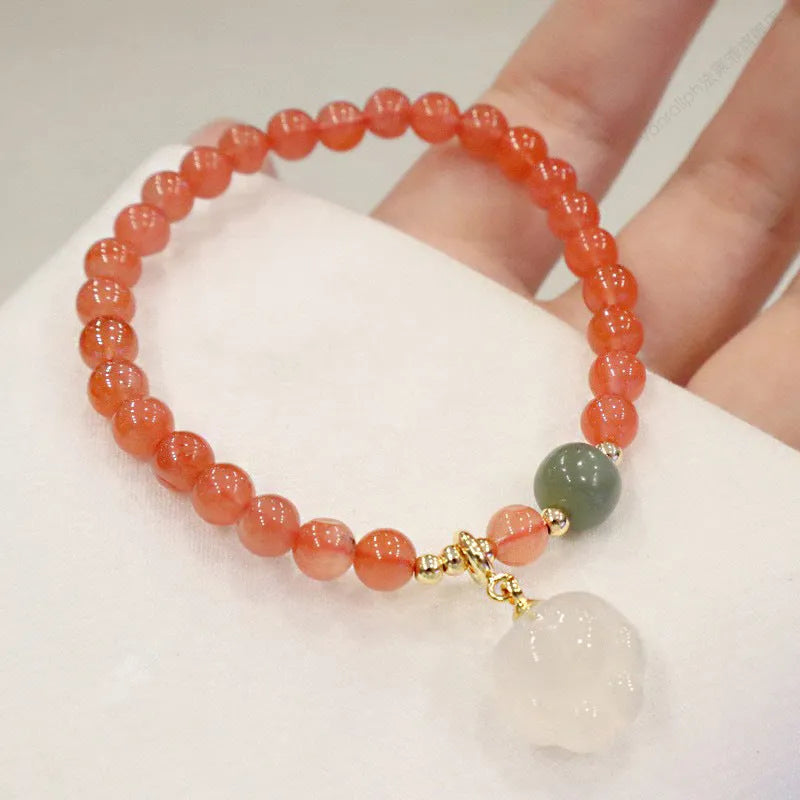 Natural red agate bracelet with jade accents showing 6mm beads and 8mm cat paw zodiac charms