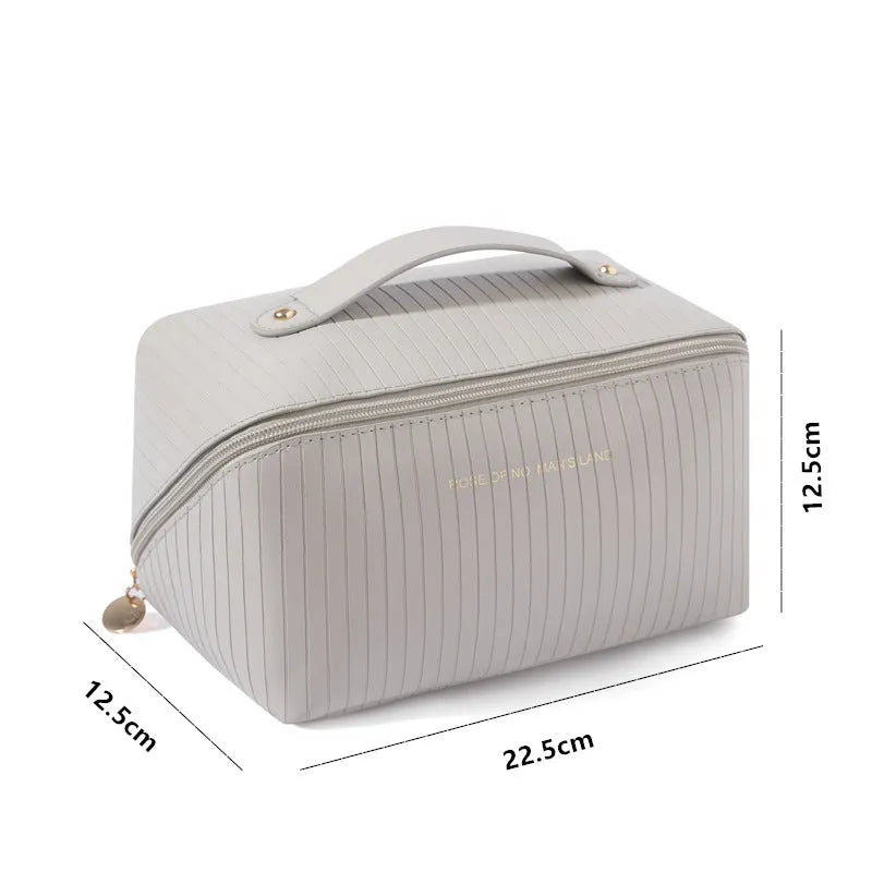 Vertical pattern pillow makeup bag in PU leather with cubic 22.5cm dimensions for travel storage