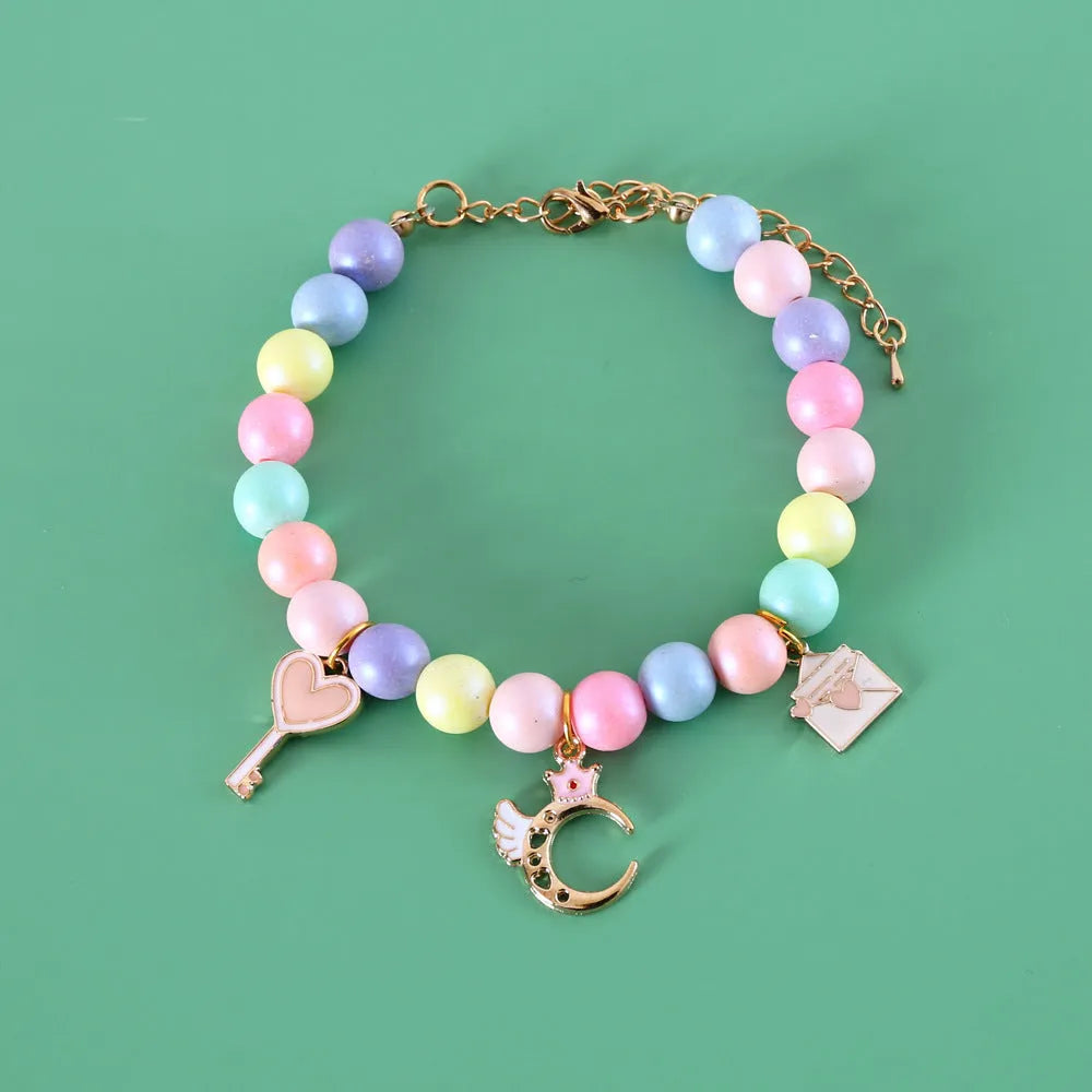 Resin pet headdress and necklace set in macaron colours on a cat or dog, showing moon and crown designs.