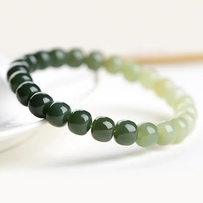 Natural Hetian jade bracelet showing gradient clear to water colour beads on elastic cord